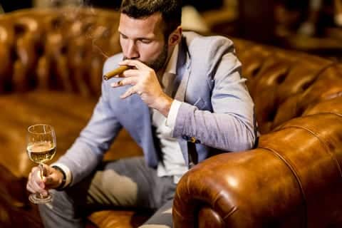 Young man tasting white wine